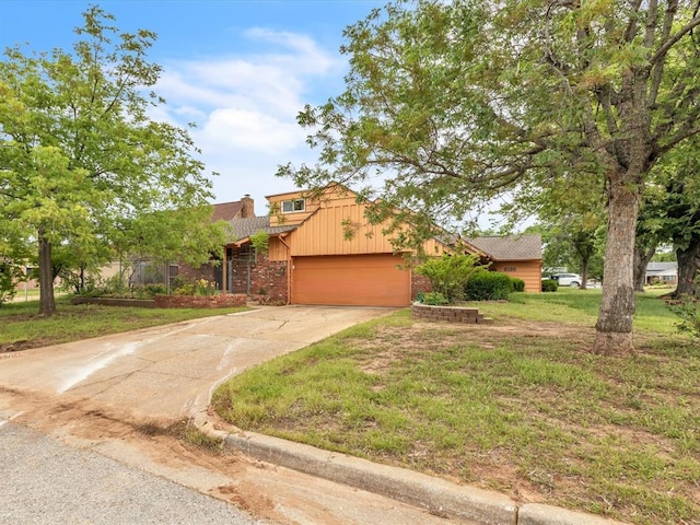 6120 Kingston Rd, Oklahoma City, OK 73122 - view of front of house featuring an attached garage, driveway, a front yard, brick siding, and a chimney