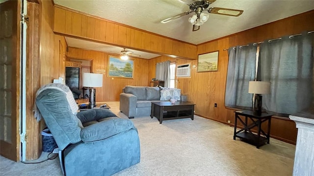 123 S 4th St, Sentinel, OK 73664 - carpeted living room featuring a ceiling fan, wooden walls, and a wall mounted air conditioner