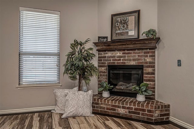 805 Evening Dr, Yukon, OK 73099 - detailed view of wood finished floors, baseboards, and a fireplace