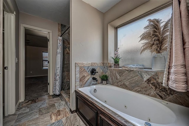 805 Evening Dr, Yukon, OK 73099 - bathroom featuring a shower stall, a whirlpool tub, stone finish flooring, and baseboards