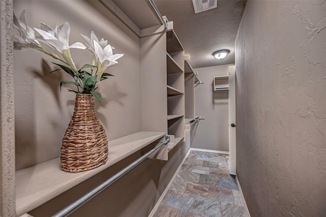 805 Evening Dr, Yukon, OK 73099 - spacious closet featuring stone tile flooring