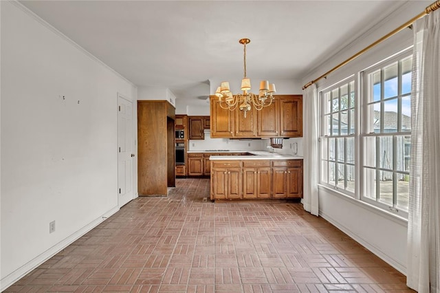 kitchen featuring a chandelier, brick patterned flooring, light countertops, black oven, and brown cabinetry