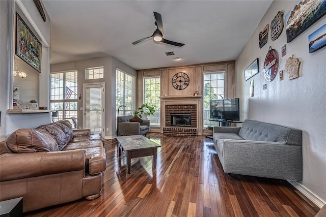 3001 NE 129th St, Edmond, OK 73013 - living area featuring a ceiling fan, dark wood-style flooring, a brick fireplace, and plenty of natural light