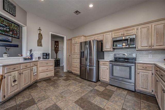 3001 NE 129th St, Edmond, OK 73013 - kitchen with appliances with stainless steel finishes, stone tile floors, backsplash, light countertops, and recessed lighting