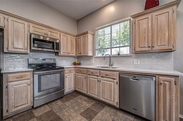 3001 NE 129th St, Edmond, OK 73013 - kitchen with appliances with stainless steel finishes, a sink, light countertops, decorative backsplash, and light brown cabinetry