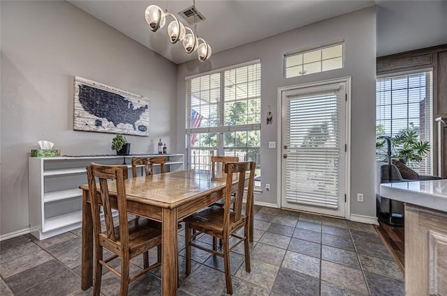 3001 NE 129th St, Edmond, OK 73013 - dining space with baseboards, healthy amount of natural light, and stone finish floors