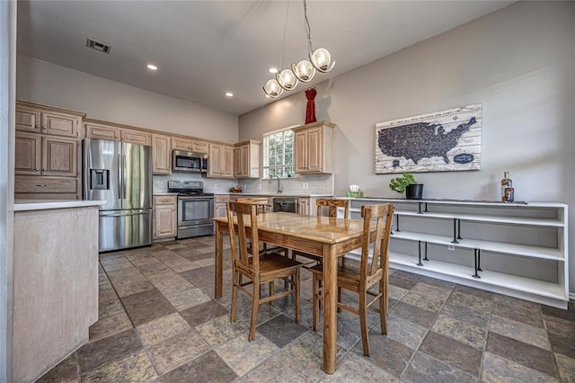 3001 NE 129th St, Edmond, OK 73013 - dining area featuring stone tile floors, recessed lighting, and a chandelier