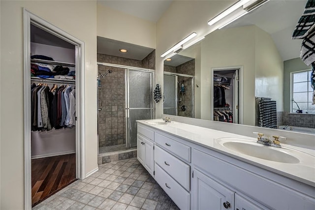 3001 NE 129th St, Edmond, OK 73013 - full bath featuring double vanity, a stall shower, a walk in closet, and lofted ceiling