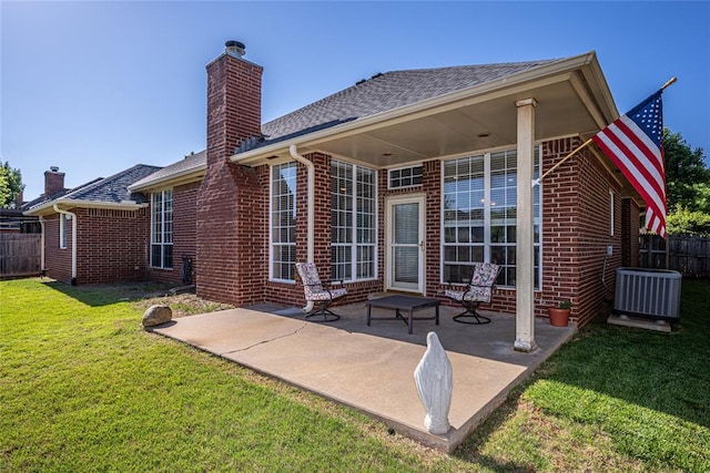 3001 NE 129th St, Edmond, OK 73013 - rear view of property featuring brick siding, a patio, a chimney, and central AC unit
