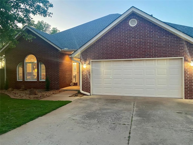 3001 NE 129th St, Edmond, OK 73013 - single story home featuring brick siding, concrete driveway, and a garage