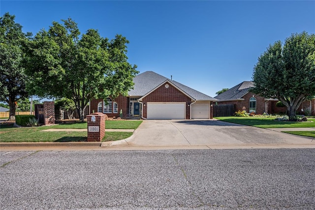 3001 NE 129th St, Edmond, OK 73013 - traditional-style house with a garage, brick siding, and concrete driveway