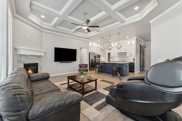 living area featuring ceiling fan, coffered ceiling, a high ceiling, beam ceiling, and a fireplace