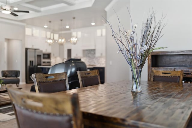 dining area featuring ceiling fan, recessed lighting, beamed ceiling, coffered ceiling, and wood finished floors
