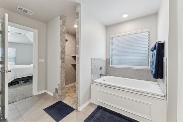 full bath featuring a bath, walk in shower, ensuite bath, tile patterned floors, and baseboards
