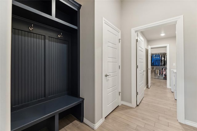 mudroom with baseboards and light wood-type flooring