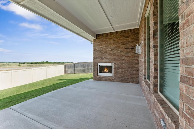 view of patio / terrace with an outdoor brick fireplace