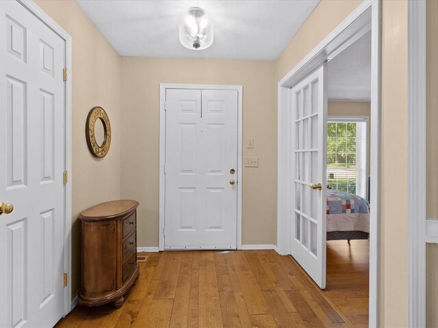2113 Castle Rock, Edmond, OK 73003 - entryway featuring light wood-style flooring, baseboards, and french doors
