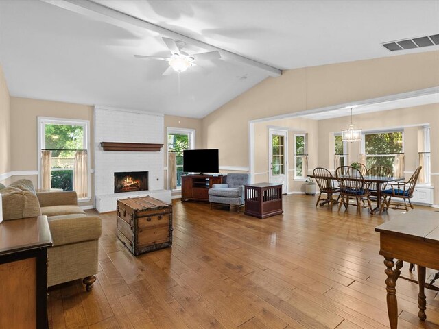 2113 Castle Rock, Edmond, OK 73003 - living area with hardwood / wood-style flooring, a ceiling fan, a fireplace, and plenty of natural light