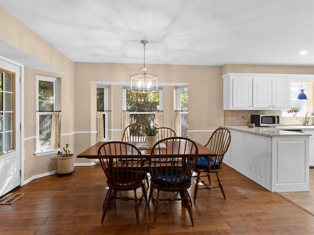 2113 Castle Rock, Edmond, OK 73003 - dining area featuring hardwood / wood-style floors, a chandelier, recessed lighting, and baseboards
