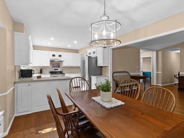 2113 Castle Rock, Edmond, OK 73003 - dining area featuring a chandelier, dark wood-type flooring, baseboards, and recessed lighting