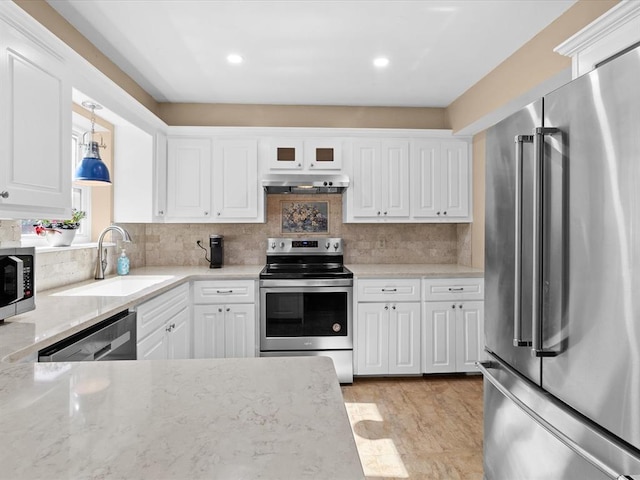 2113 Castle Rock, Edmond, OK 73003 - kitchen with stainless steel appliances, a sink, under cabinet range hood, white cabinets, and decorative backsplash