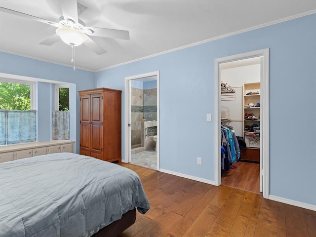 2113 Castle Rock, Edmond, OK 73003 - bedroom with hardwood / wood-style flooring, ornamental molding, baseboards, a walk in closet, and a closet