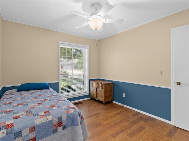 2113 Castle Rock, Edmond, OK 73003 - bedroom featuring wood finished floors, ornamental molding, baseboards, and ceiling fan