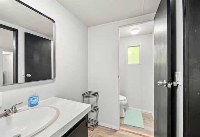 168 Bobber Rd, Broken Bow, OK 74728 - half bath with wood finished floors, toilet, vanity, and baseboards