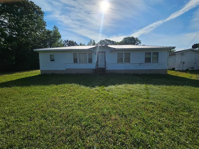 720 Mudline Rd, Eagletown, OK 74734 - rear view of house featuring entry steps, a lawn, and metal roof