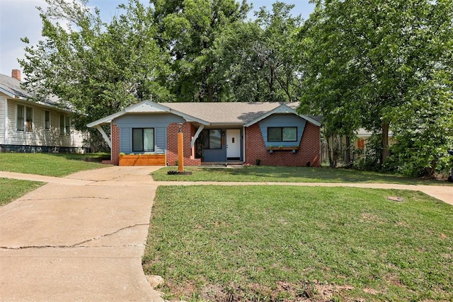 1316 W Logan Ave, Guthrie, OK 73044 - view of front facade featuring brick siding, a front yard, and driveway