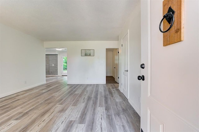 1316 W Logan Ave, Guthrie, OK 73044 - unfurnished living room featuring light wood finished floors and baseboards