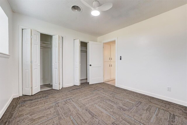 1316 W Logan Ave, Guthrie, OK 73044 - unfurnished bedroom with baseboards, two closets, and carpet floors