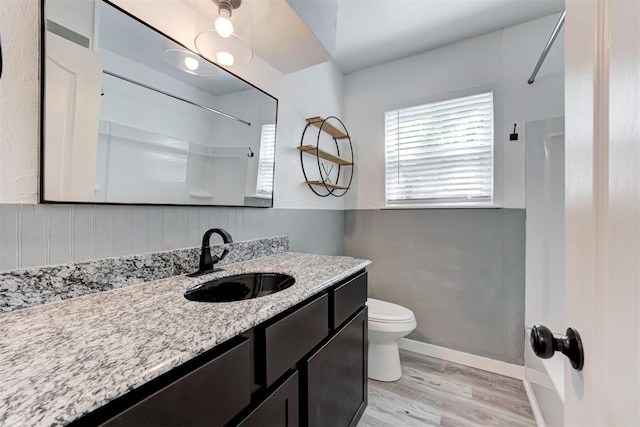 1316 W Logan Ave, Guthrie, OK 73044 - full bathroom featuring a shower, toilet, wood finished floors, vanity, and baseboards