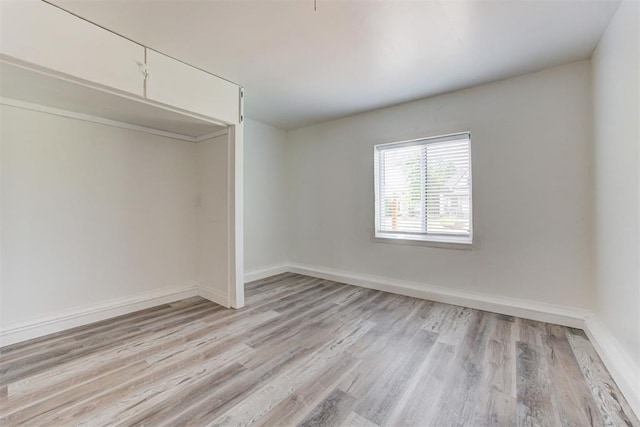 1316 W Logan Ave, Guthrie, OK 73044 - unfurnished bedroom featuring light wood-style floors, baseboards, and a closet