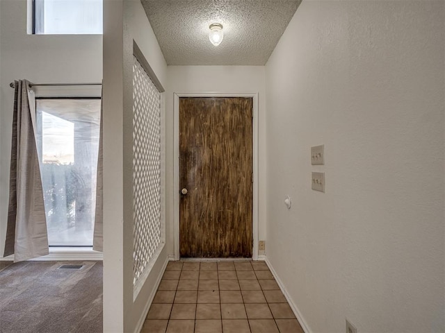 1108 SW 118th Pl, Oklahoma City, OK 73170 - foyer entrance with a textured ceiling, healthy amount of natural light, and light tile patterned floors
