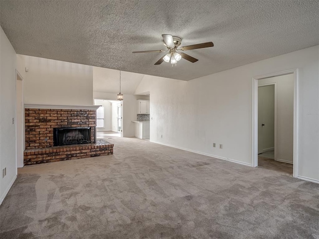1108 SW 118th Pl, Oklahoma City, OK 73170 - unfurnished living room featuring ceiling fan, carpet, a textured ceiling, a fireplace, and baseboards