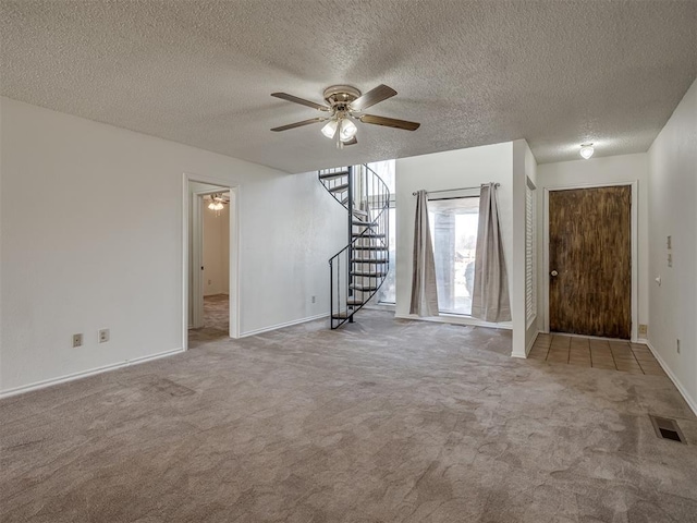 1108 SW 118th Pl, Oklahoma City, OK 73170 - foyer featuring ceiling fan, stairway, carpet flooring, baseboards, and a textured ceiling