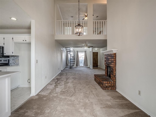 1108 SW 118th Pl, Oklahoma City, OK 73170 - unfurnished living room with stairs, a chandelier, light colored carpet, baseboards, and ceiling fan