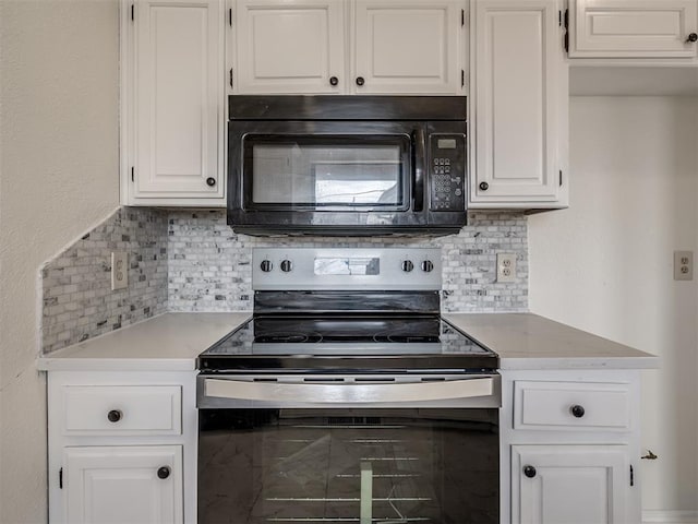 1108 SW 118th Pl, Oklahoma City, OK 73170 - kitchen with black microwave, stainless steel electric stove, light countertops, backsplash, and white cabinetry