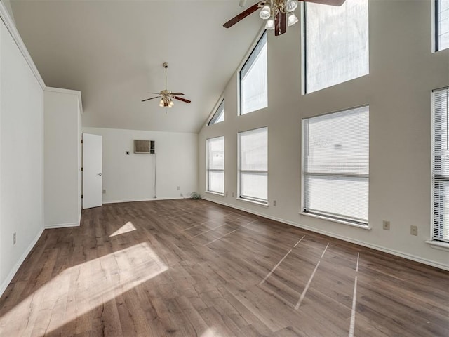 1108 SW 118th Pl, Oklahoma City, OK 73170 - unfurnished living room with ceiling fan, high vaulted ceiling, wood finished floors, baseboards, and a wall mounted air conditioner