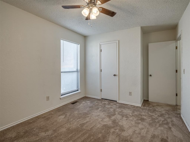 1108 SW 118th Pl, Oklahoma City, OK 73170 - unfurnished bedroom with a textured ceiling, carpet floors, a ceiling fan, and baseboards