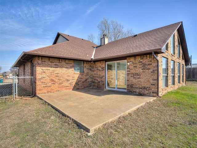 1108 SW 118th Pl, Oklahoma City, OK 73170 - back of house featuring brick siding, a chimney, roof with shingles, and a patio area