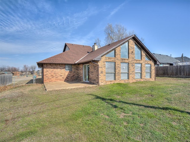 1108 SW 118th Pl, Oklahoma City, OK 73170 - rear view of house with a patio area, roof with shingles, brick siding, and a chimney