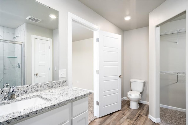 12700 Torretta Way, Yukon, OK 73099 - full bath featuring a shower stall, a spacious closet, wood finished floors, toilet, and recessed lighting