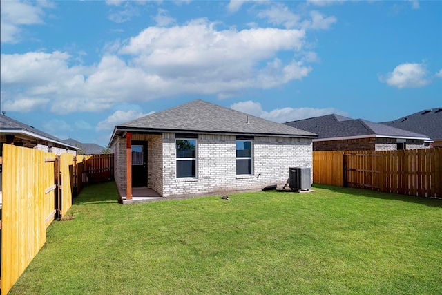 12700 Torretta Way, Yukon, OK 73099 - back of house featuring brick siding, central AC unit, and roof with shingles