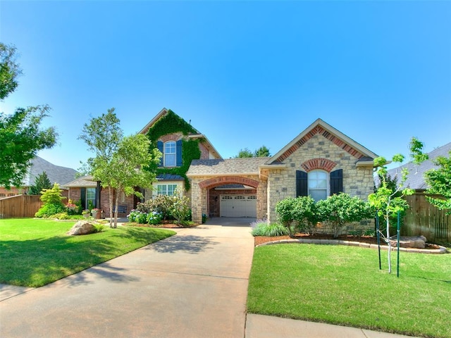 7612 NW 134th St, Oklahoma City, OK 73142 - view of front of house with driveway, stone siding, and a garage