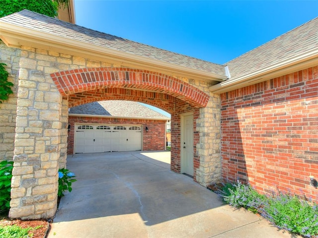 7612 NW 134th St, Oklahoma City, OK 73142 - view of patio featuring driveway and a garage