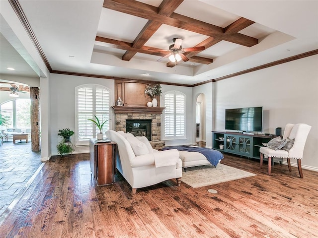 7612 NW 134th St, Oklahoma City, OK 73142 - living area featuring ceiling fan, baseboards, wood finished floors, coffered ceiling, and a fireplace