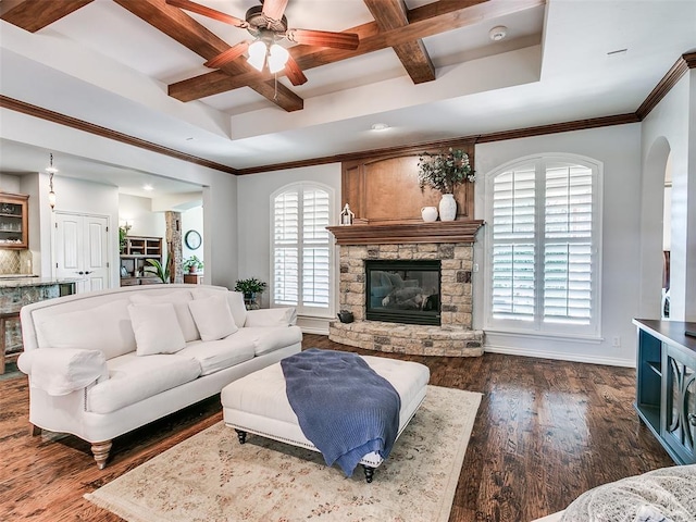 7612 NW 134th St, Oklahoma City, OK 73142 - living area with coffered ceiling, healthy amount of natural light, a ceiling fan, a stone fireplace, and beam ceiling