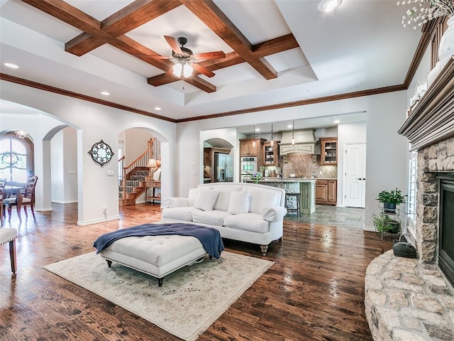 7612 NW 134th St, Oklahoma City, OK 73142 - living area with arched walkways, coffered ceiling, stairway, recessed lighting, and a ceiling fan